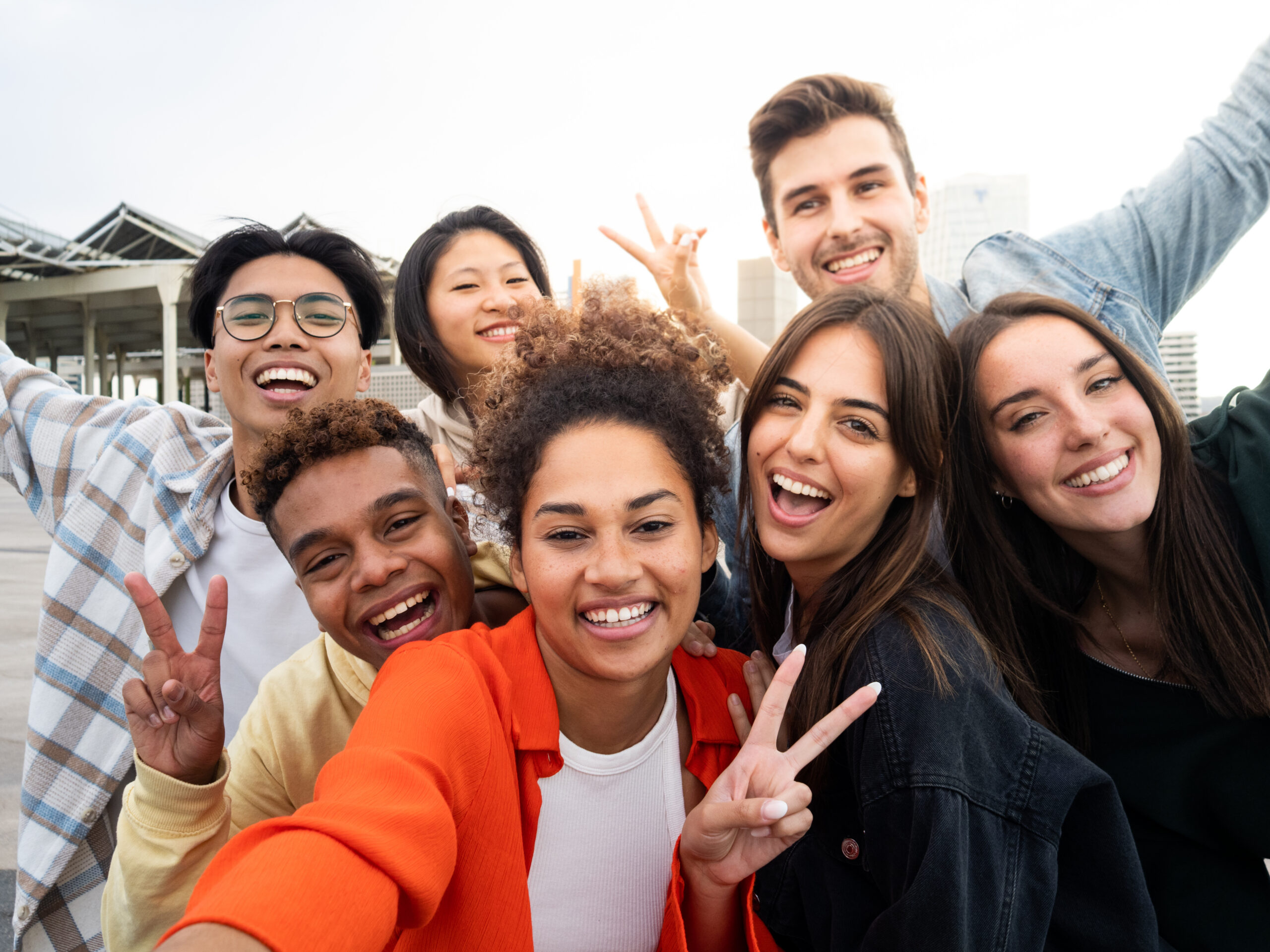 Gen Zers taking a group photo before implementing a customer acquisition strategy