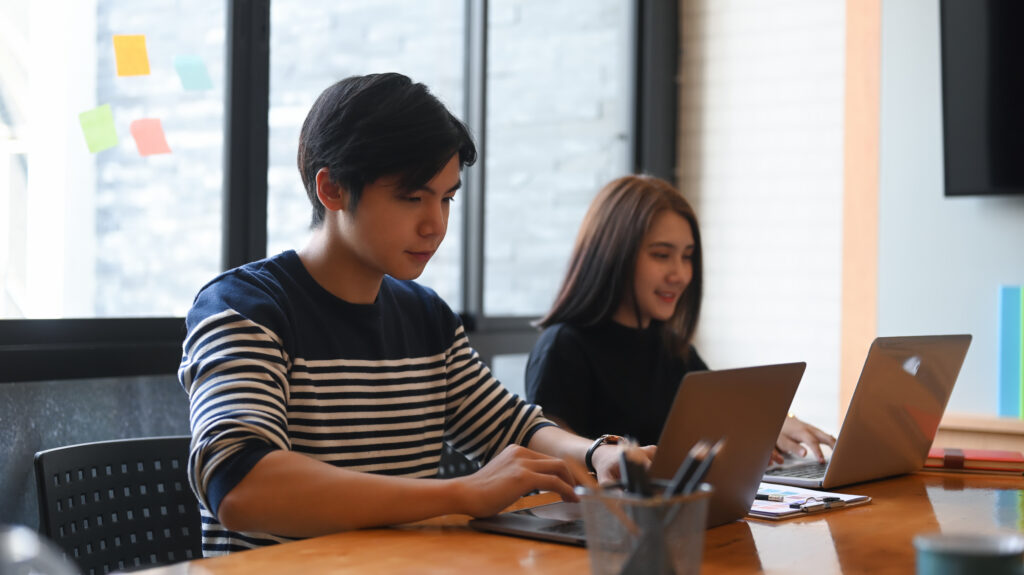 Sales and marketing interns on their laptops